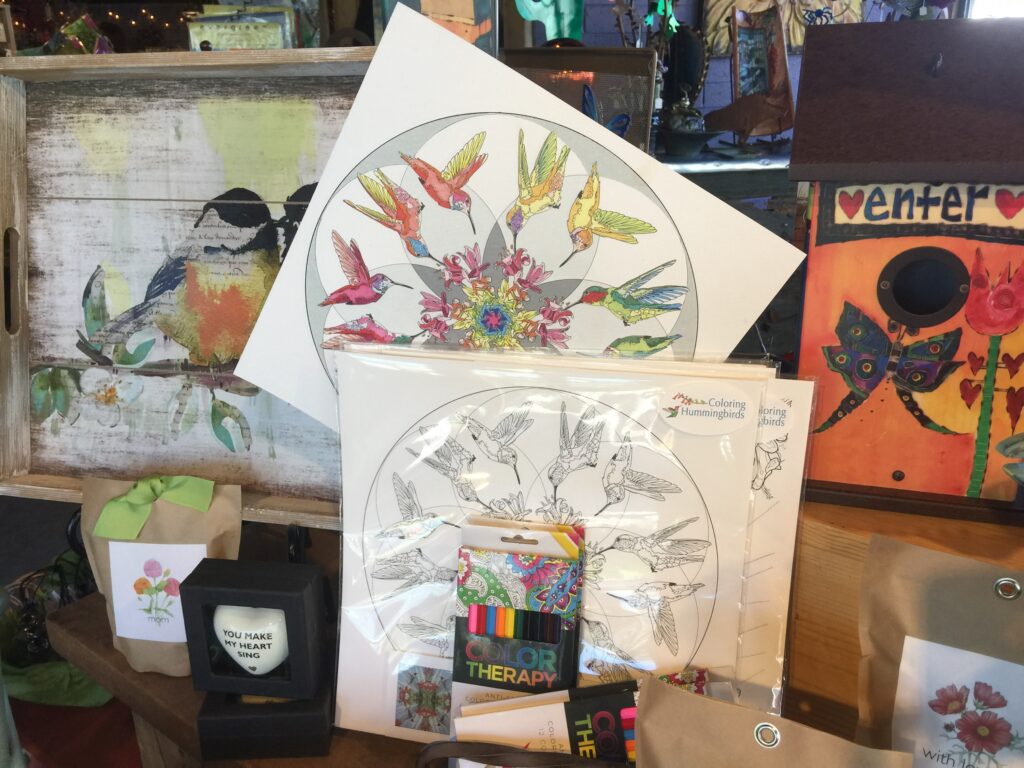 Coloring Hummingbird coloring sheet folios on display with a hummingbird mandala colored in as part of the display